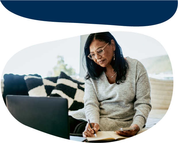 Adult writing in a notebook