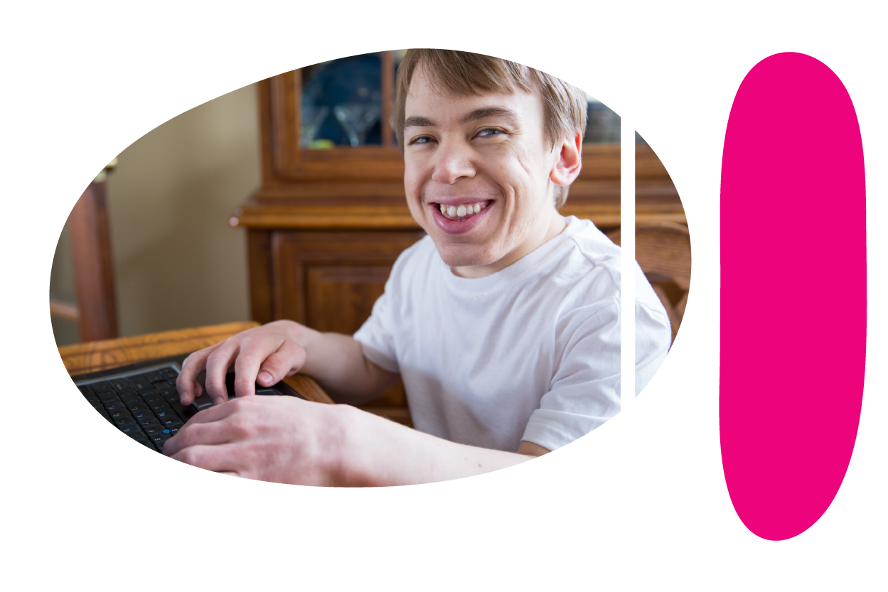 Person smiling and typing on a computer