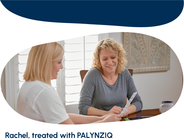 A doctor and an adult talking and looking at a sheet of paper