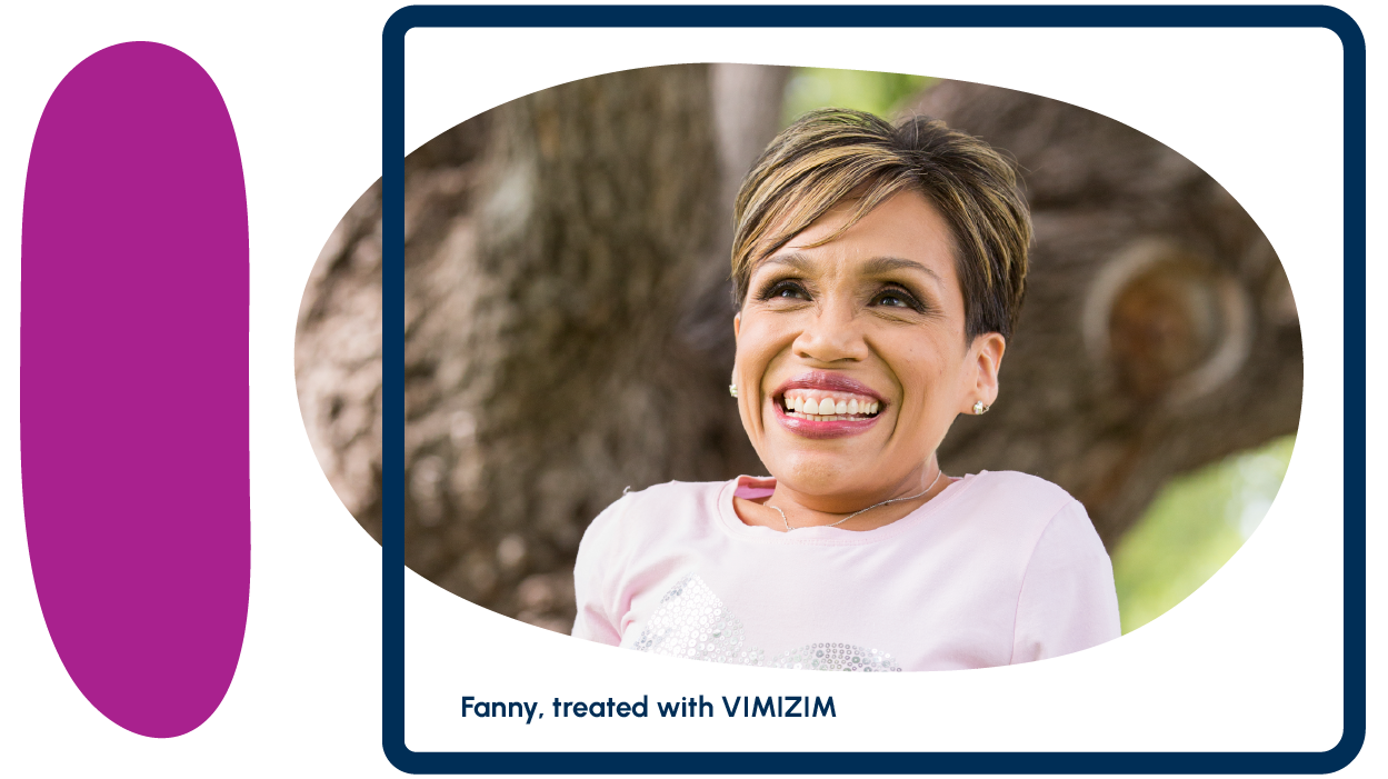 A smiling adult person against a tree